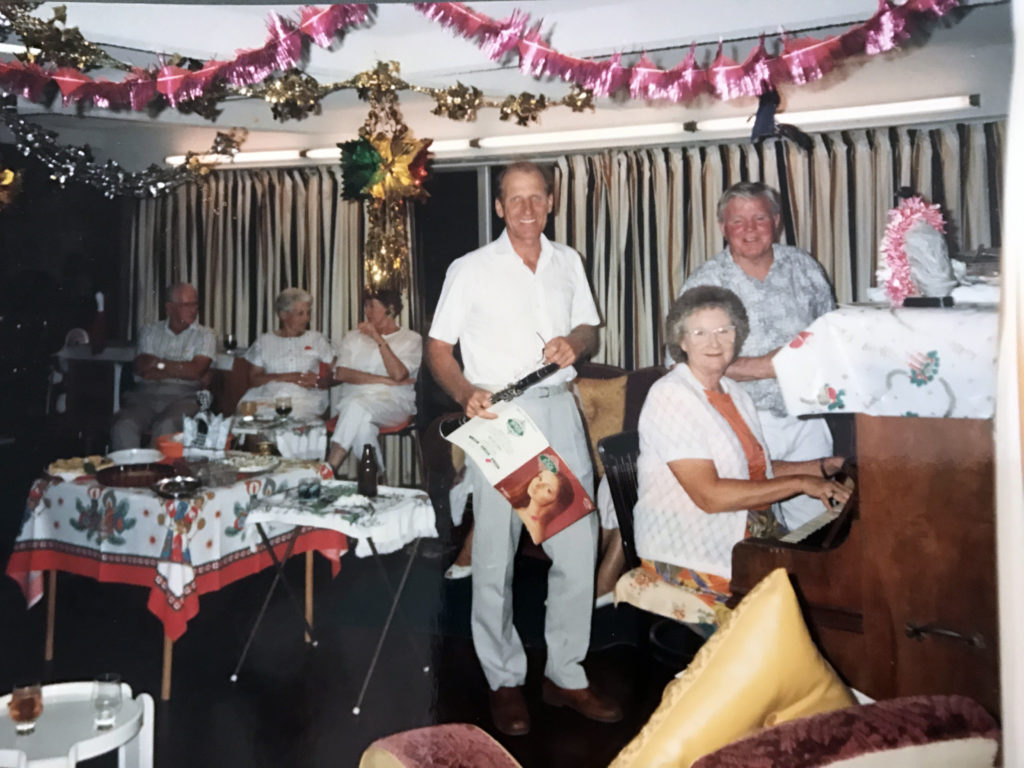 Betty Geise playing piano at party