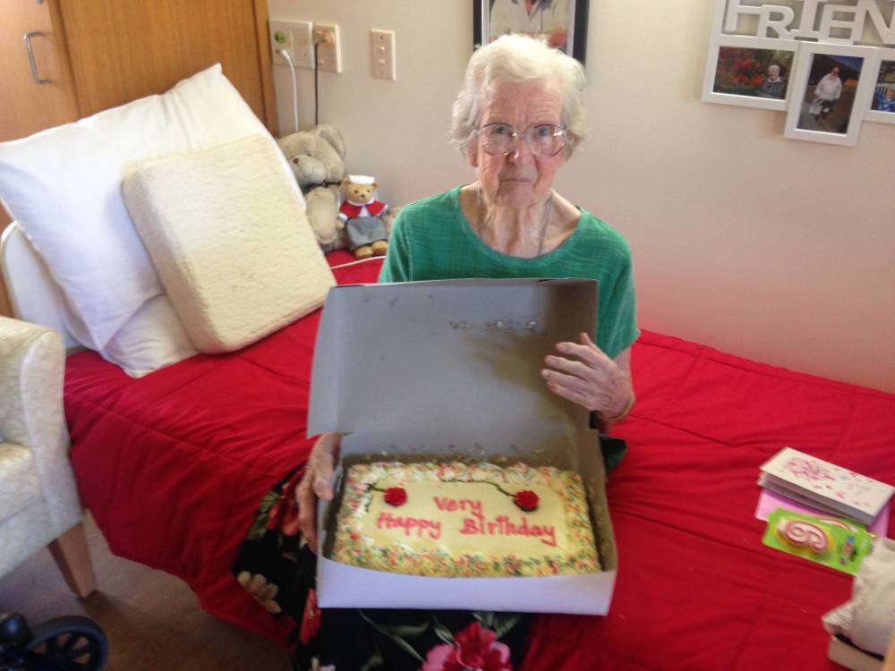 Margarita with her birthday cake. She turned 97 the day this article was published. (Image supplied.)