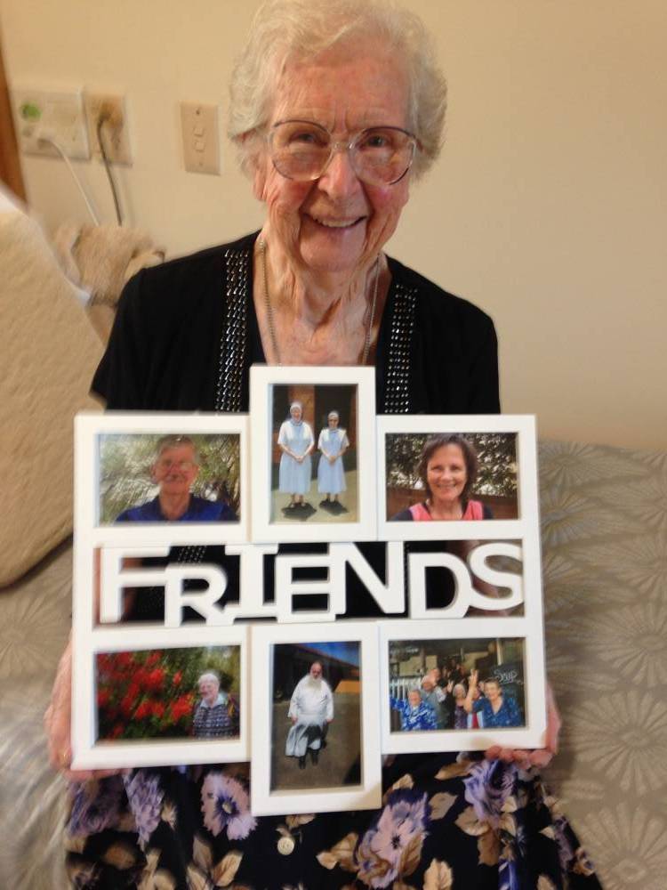 Margarita with photos of some of her friends. (Image supplied.)