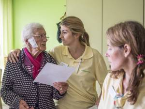 A staff member puts her arm around a resident. Image supplied.