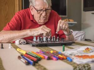 Resident concentrates on a game of chess. 