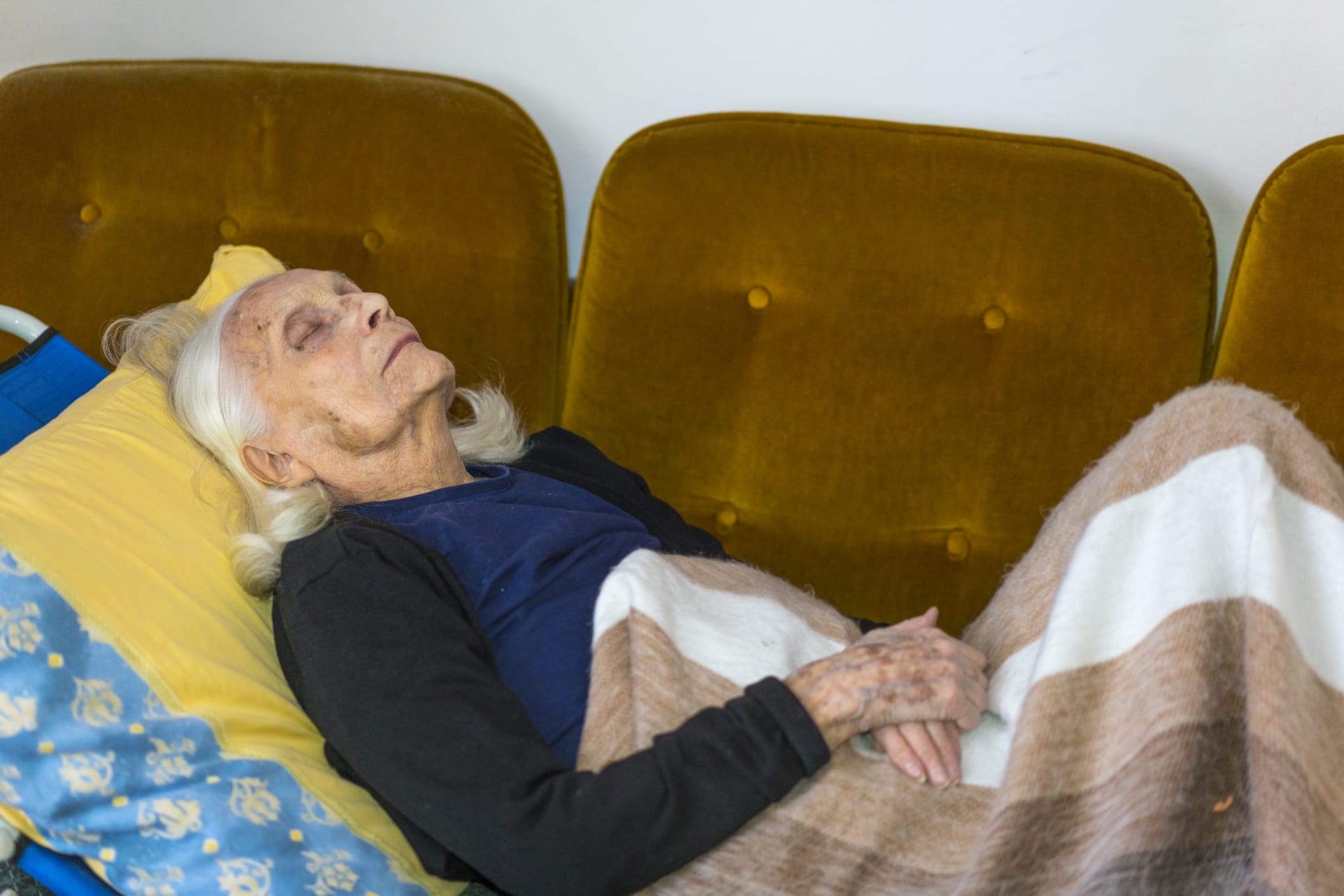View portrait of Senior woman in living room sleeping on sofa at time of COVID-19