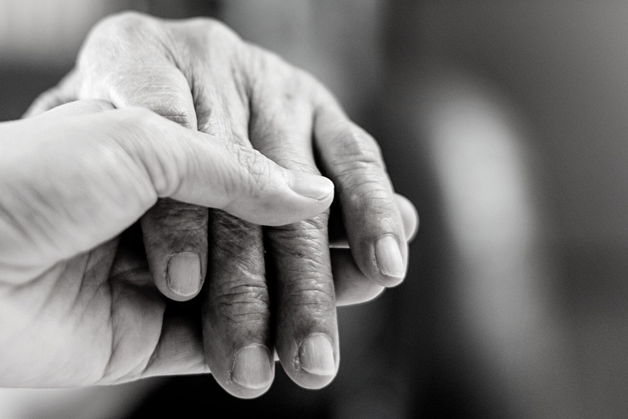 Carer & resident holding hands