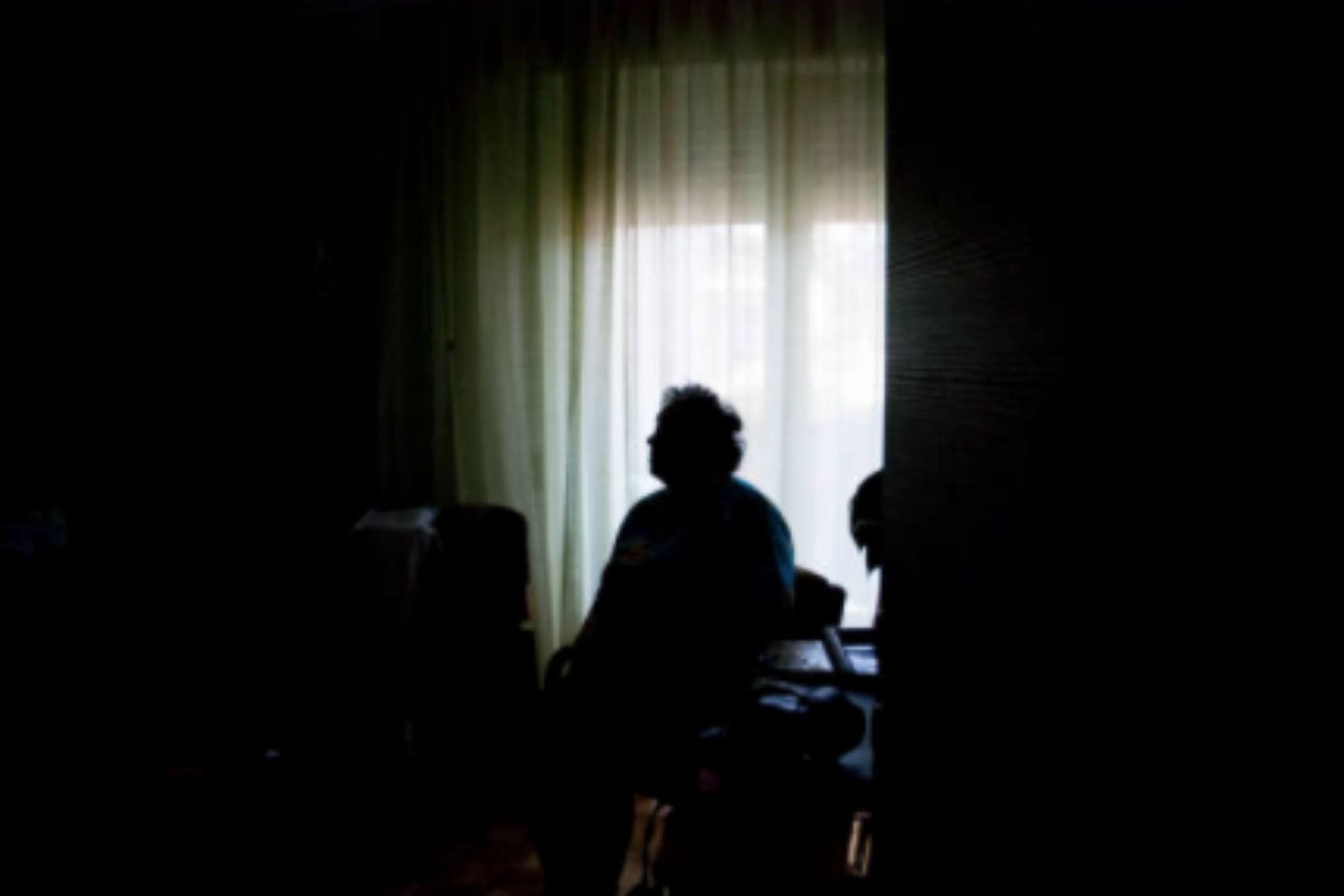 Senior woman alone in dark room