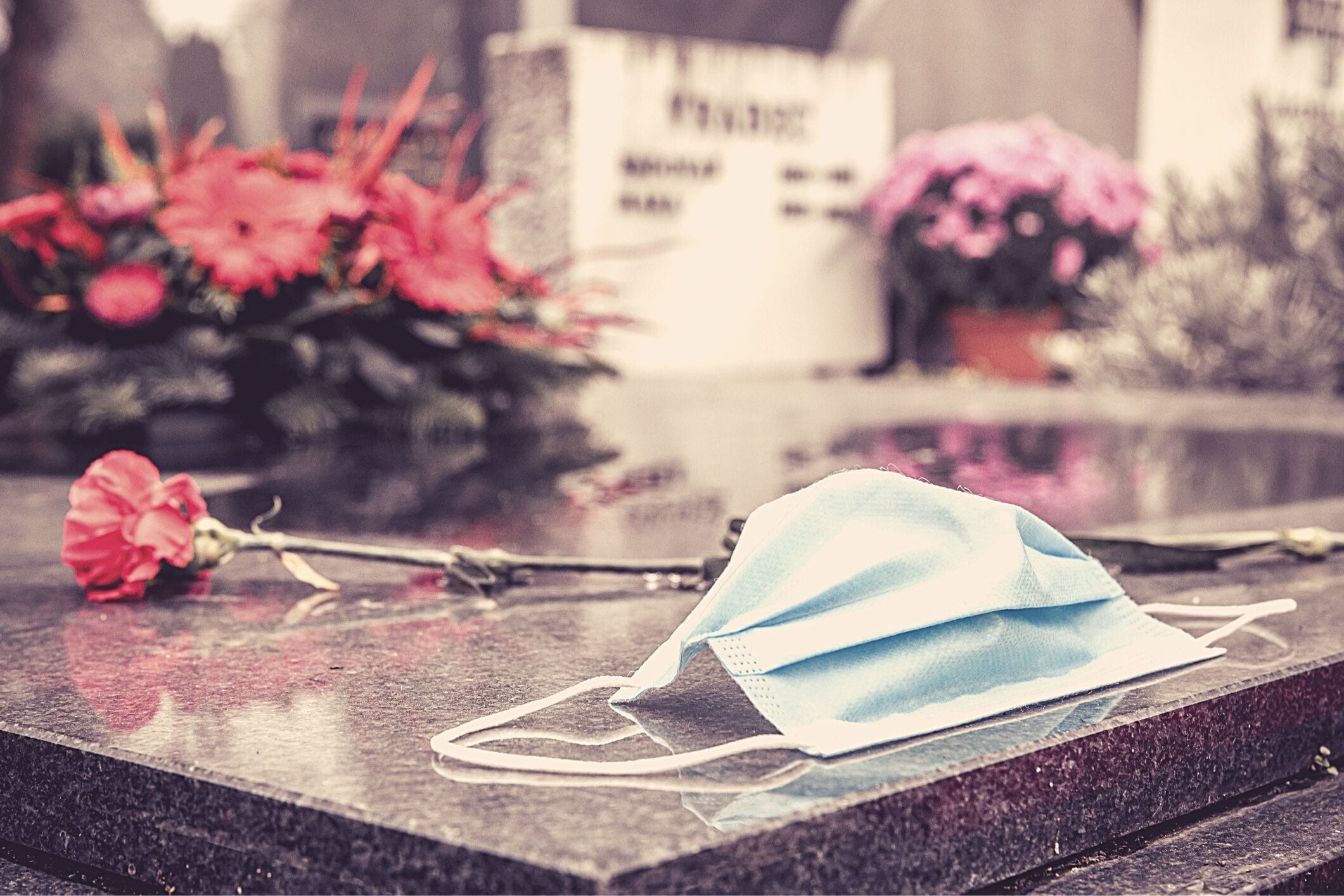 Surgical mask on tombstone