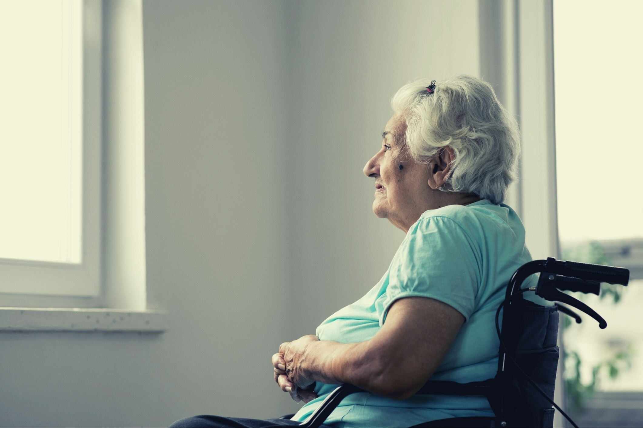 Resident in wheelchair looking out window