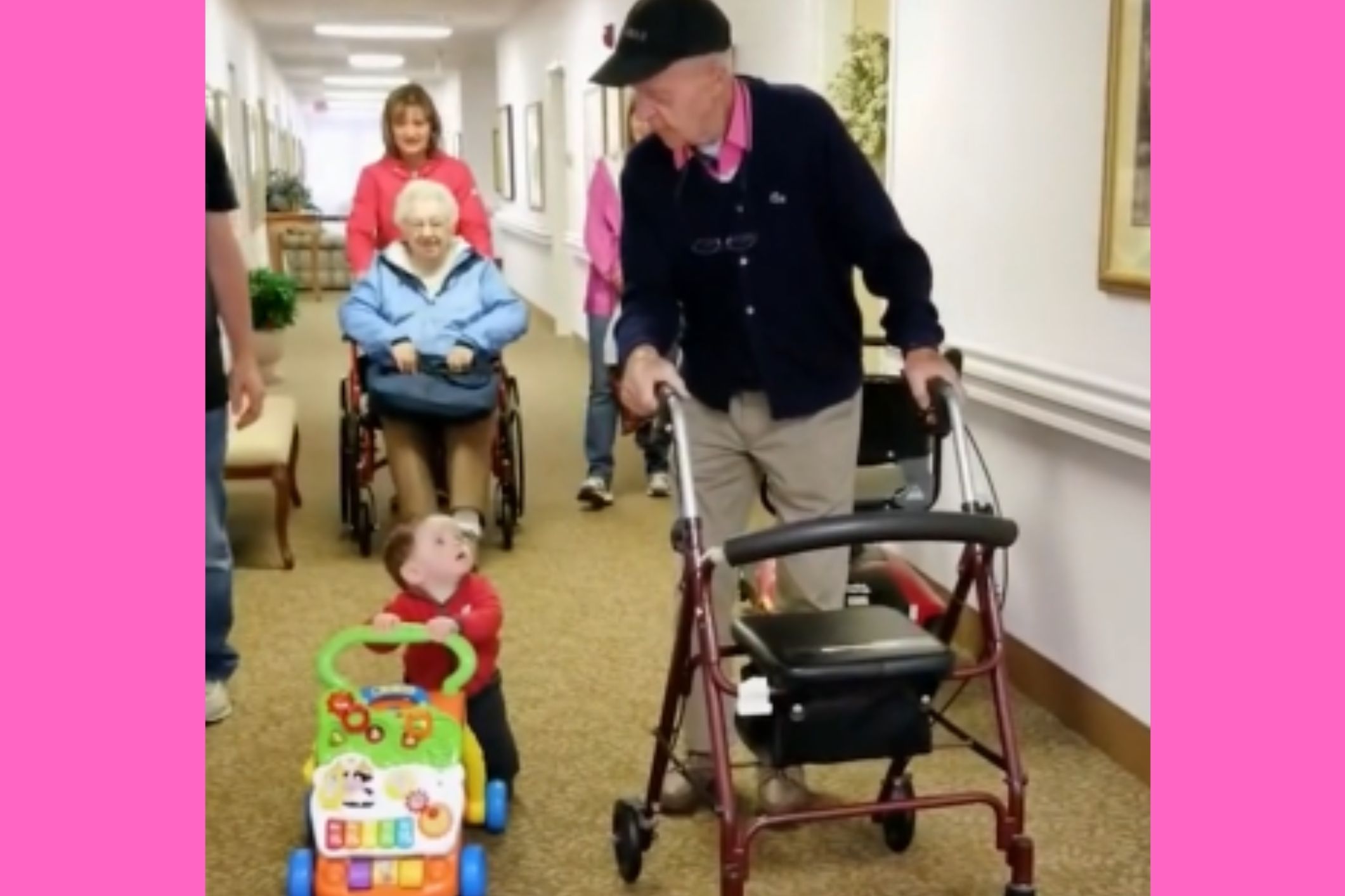 Spurring each other on, Great-Grandfather and baby use walkers in unison