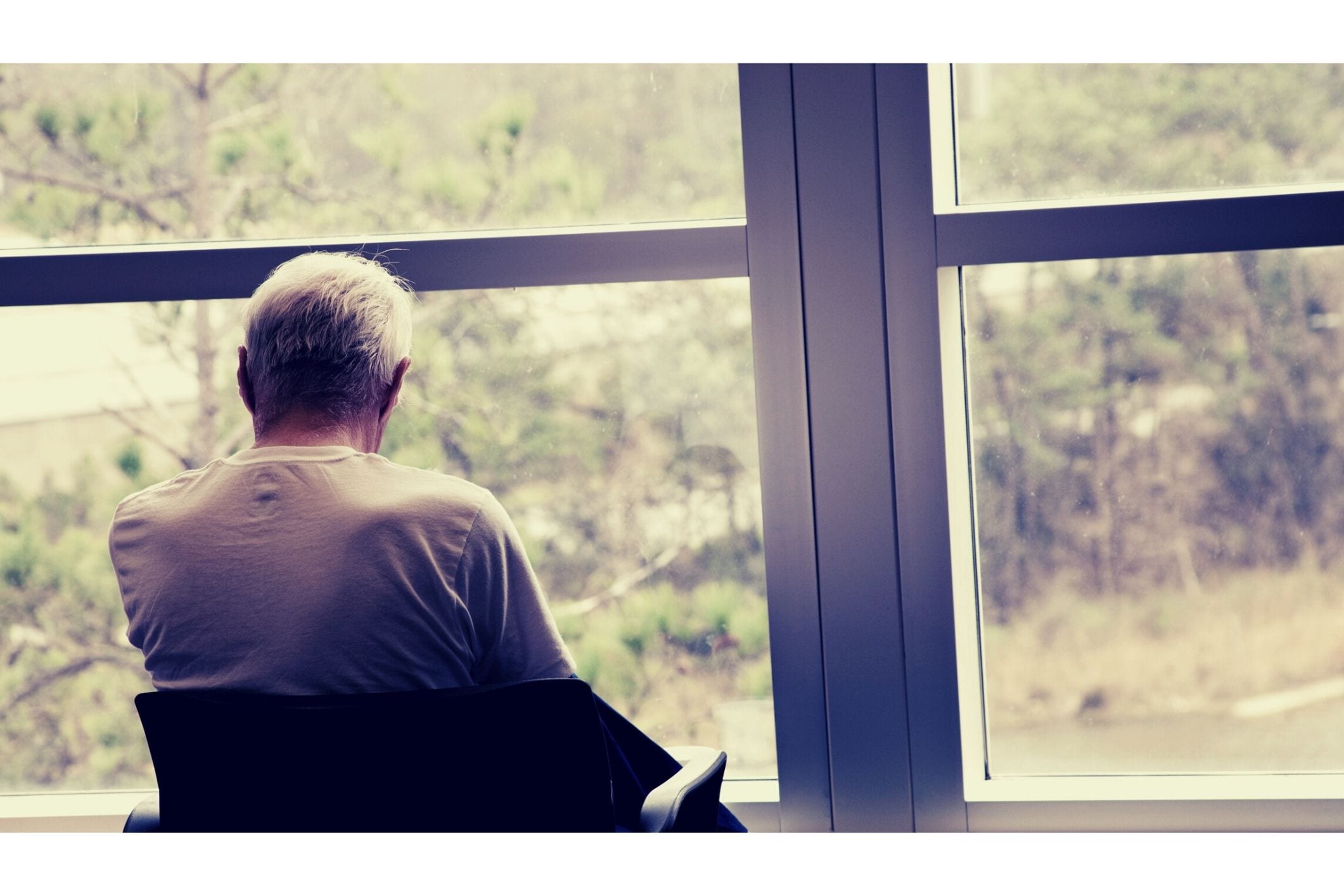 Male resident sitting by window