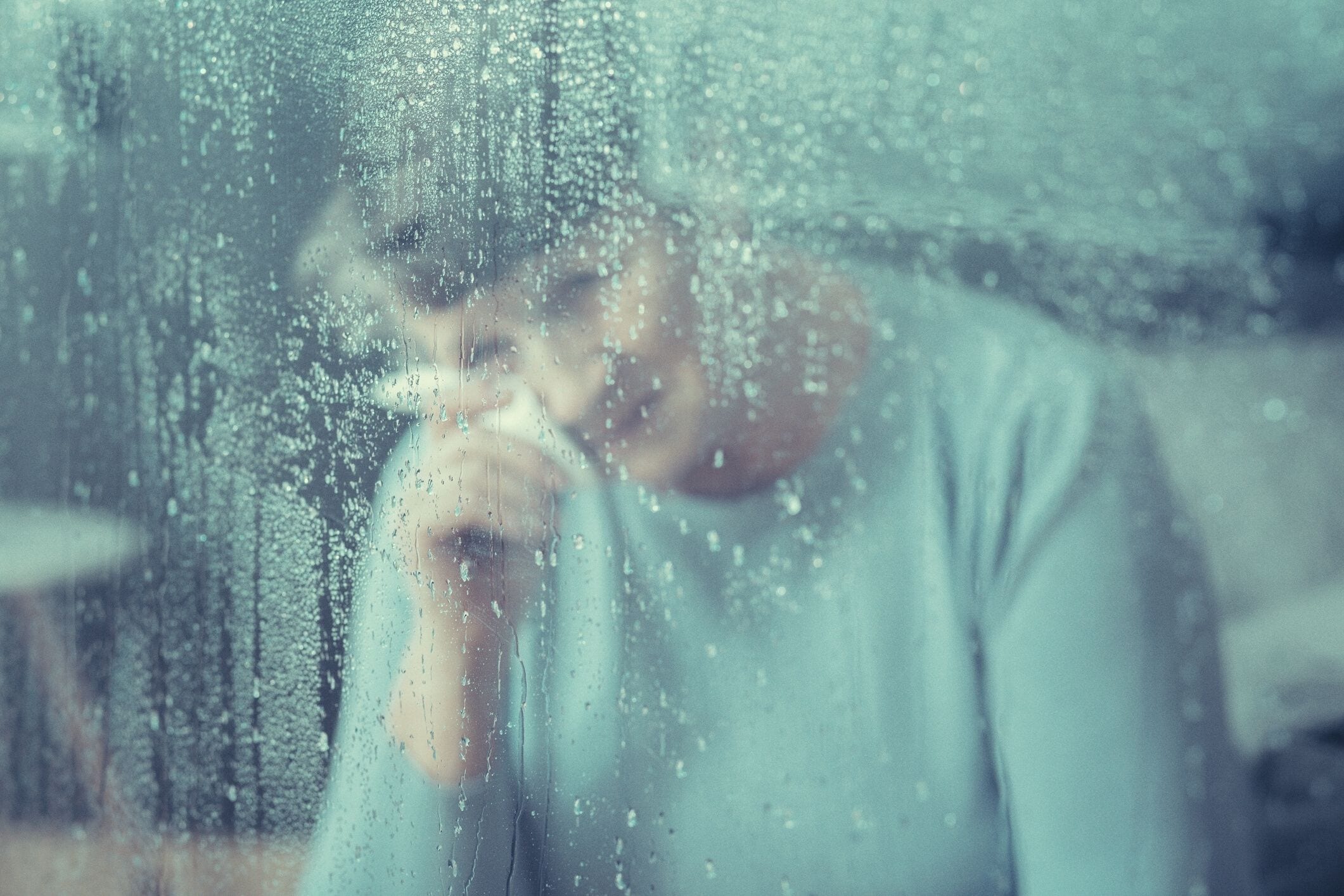 Older woman crying by window
