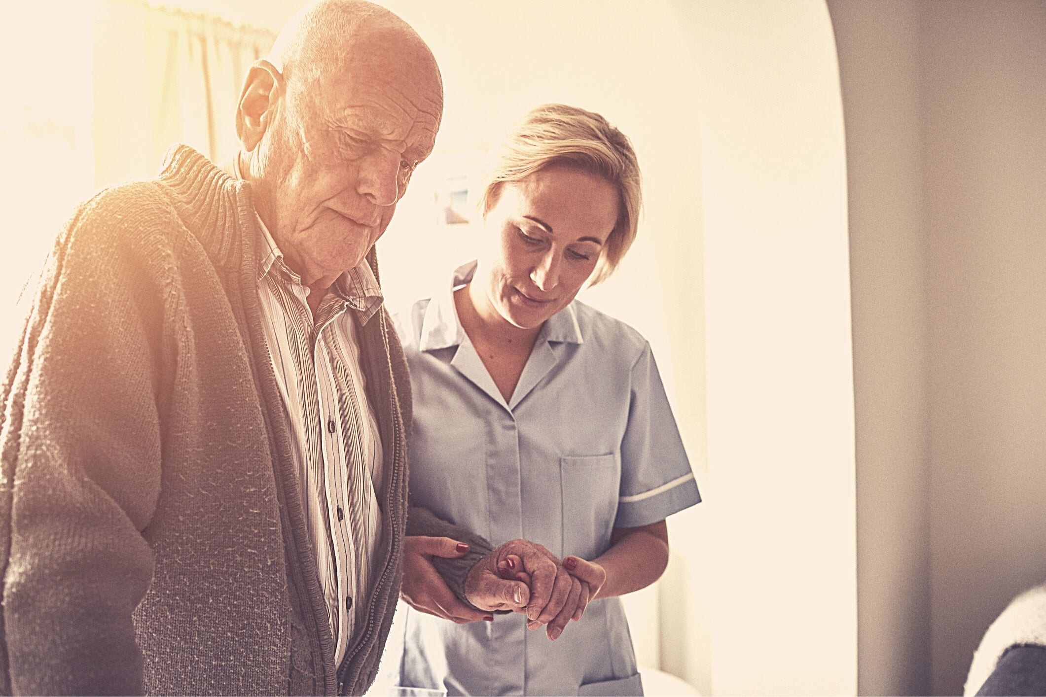 Carer helping man walk