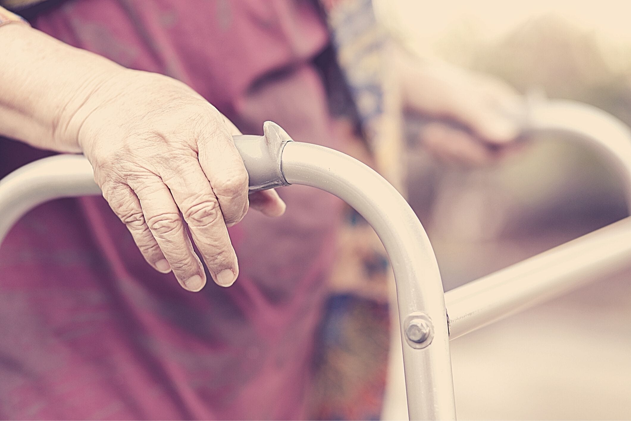 Elderly woman using walker