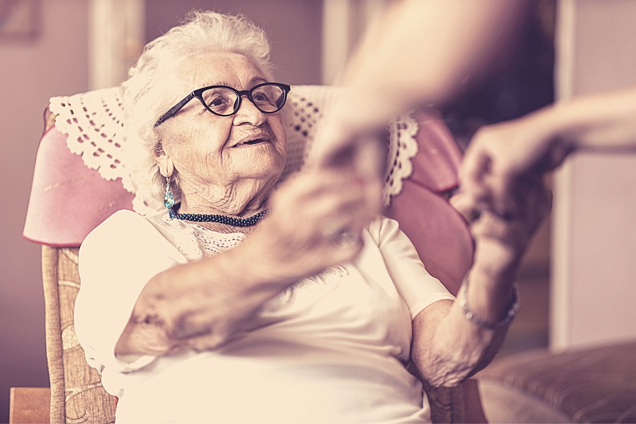 Home carer helping older woman