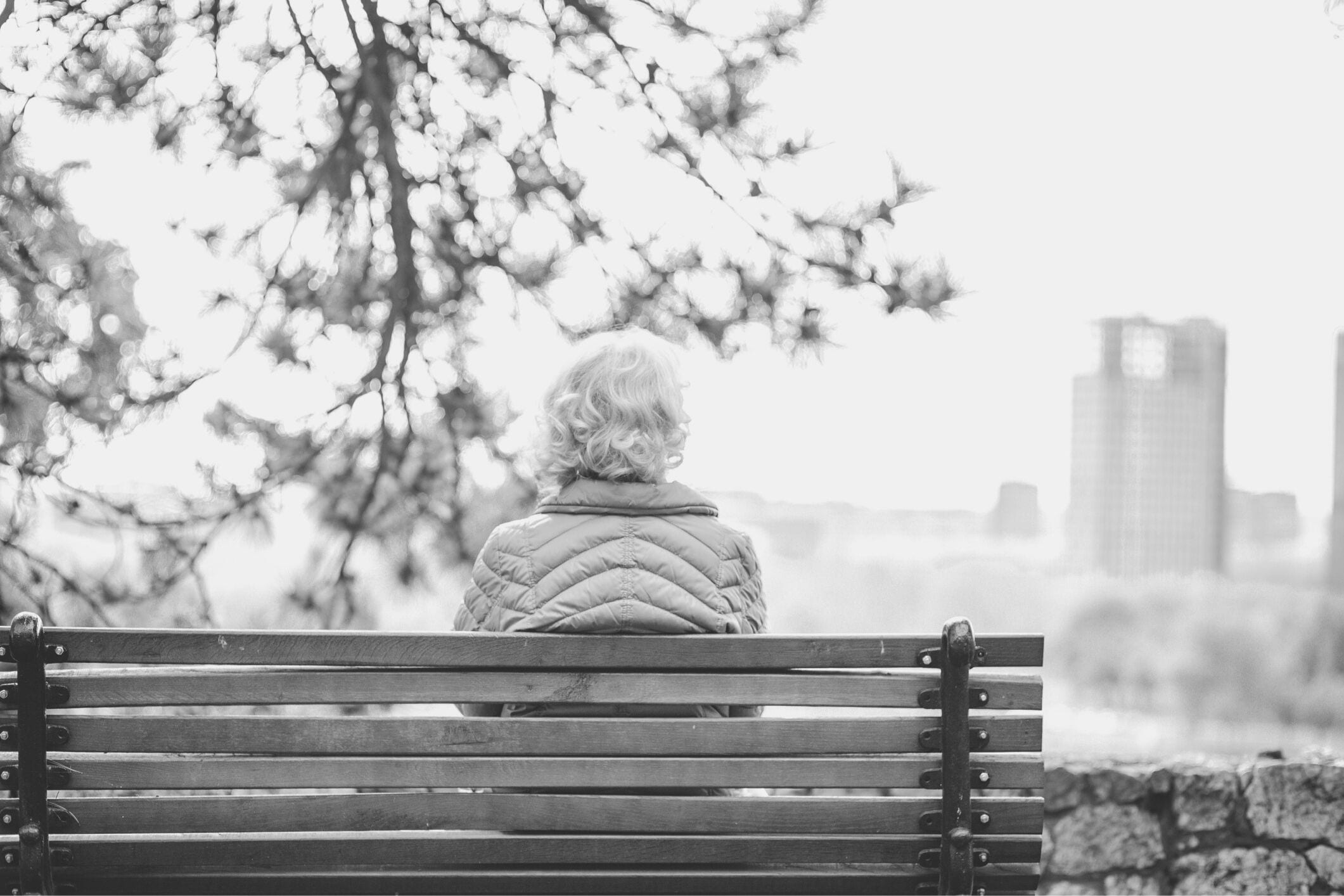 Lonely senior woman park bench