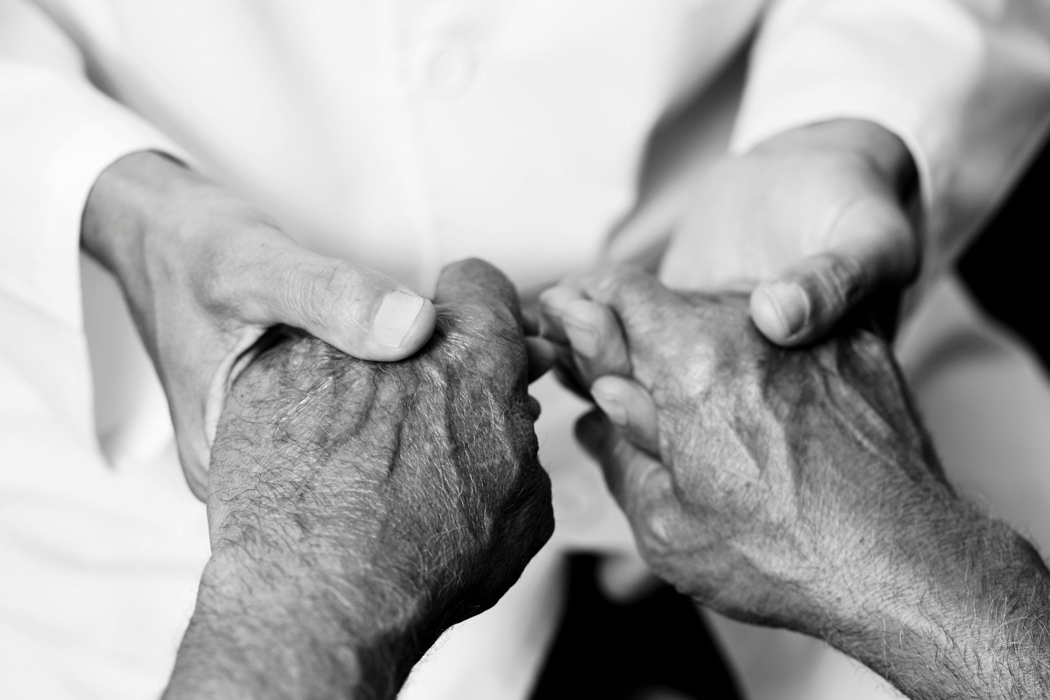 Man holding hands of senior man
