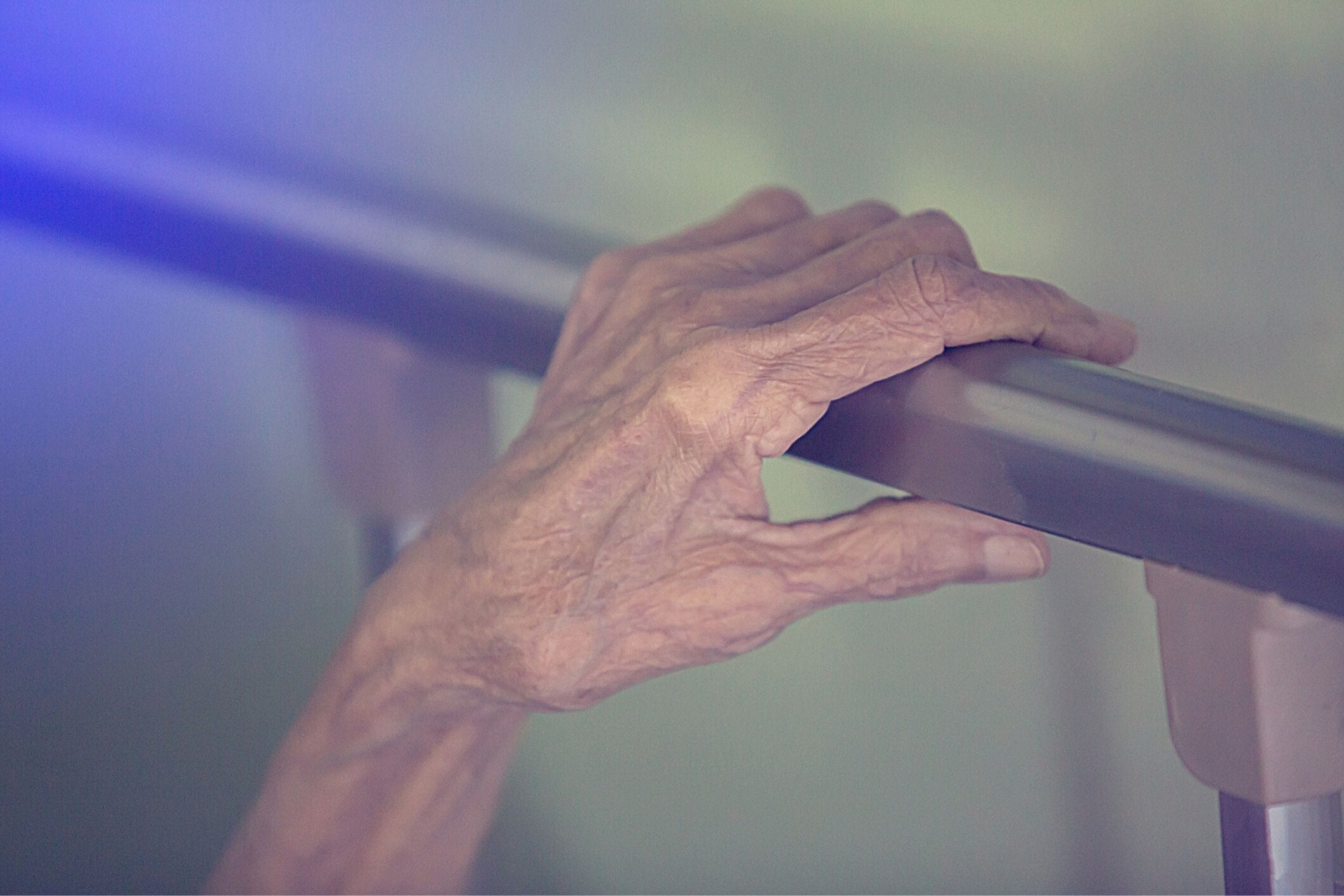 Senior's hand on bed rail