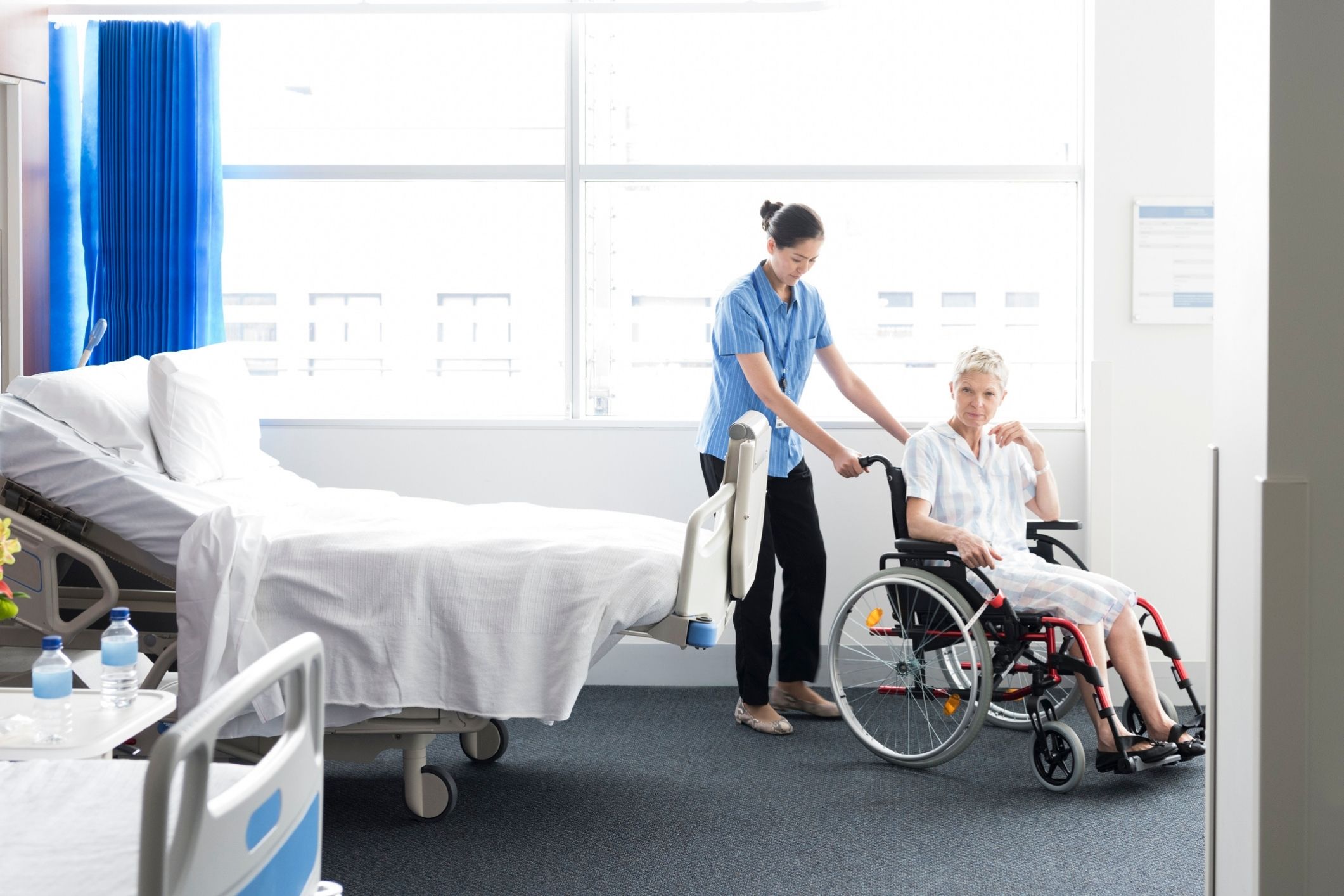 Nurse helping aged care hospital patient