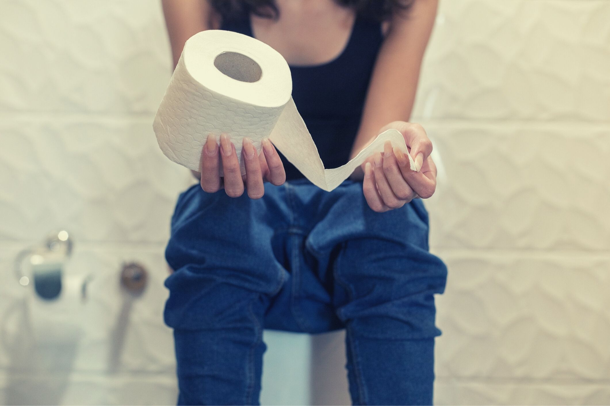 Woman sitting on toilet