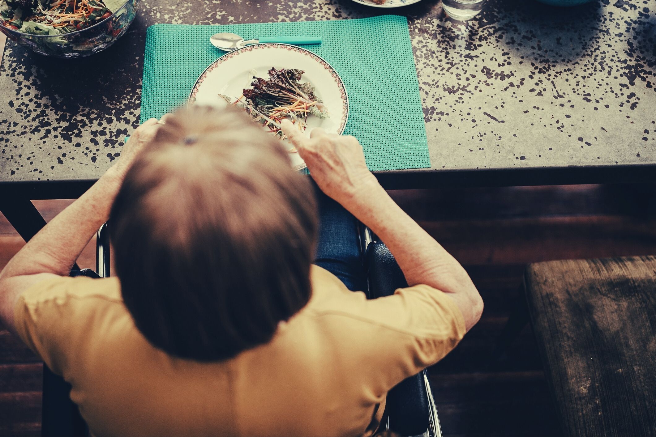 Aged care resident eating meal in home