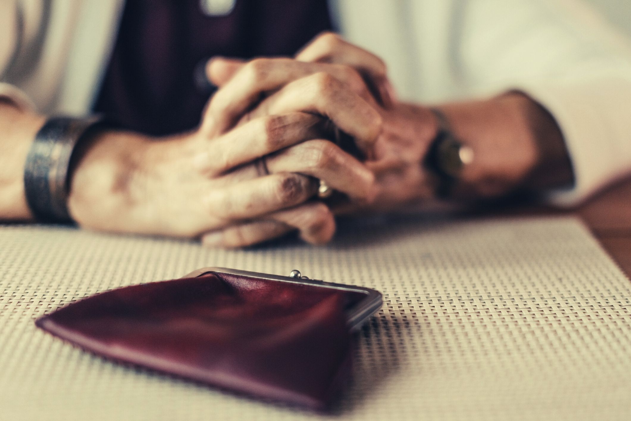 Old woman counting coins from purse