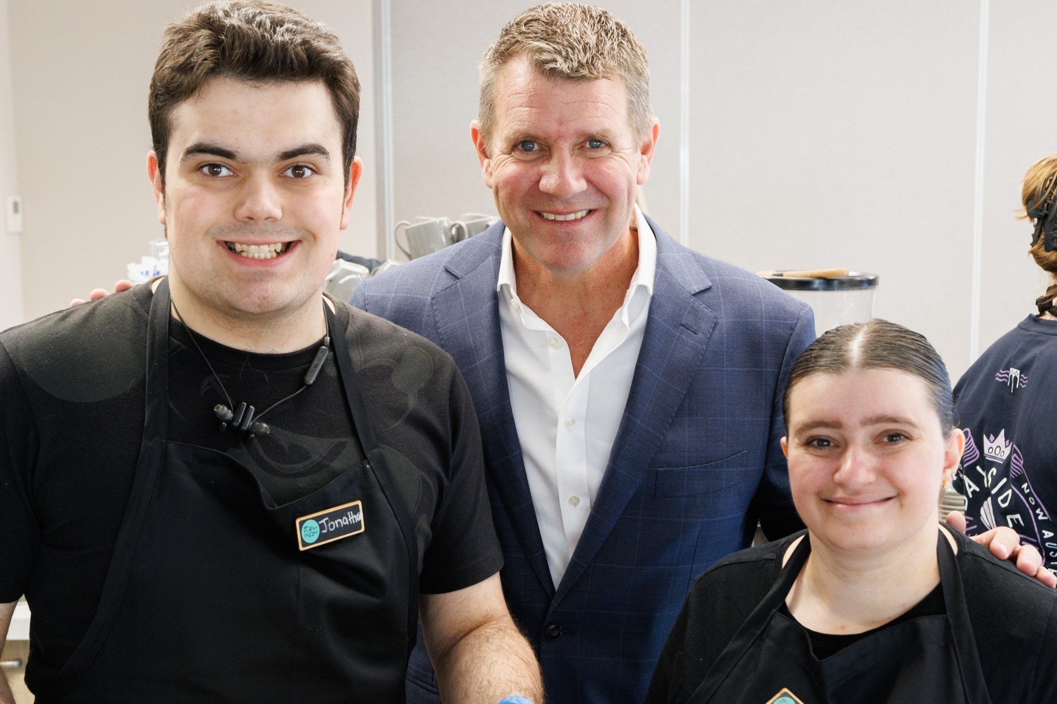 HammondCare CEO Mike Baird (centre) with Plant Room Cafe staff Jonathon and Izzy (square)